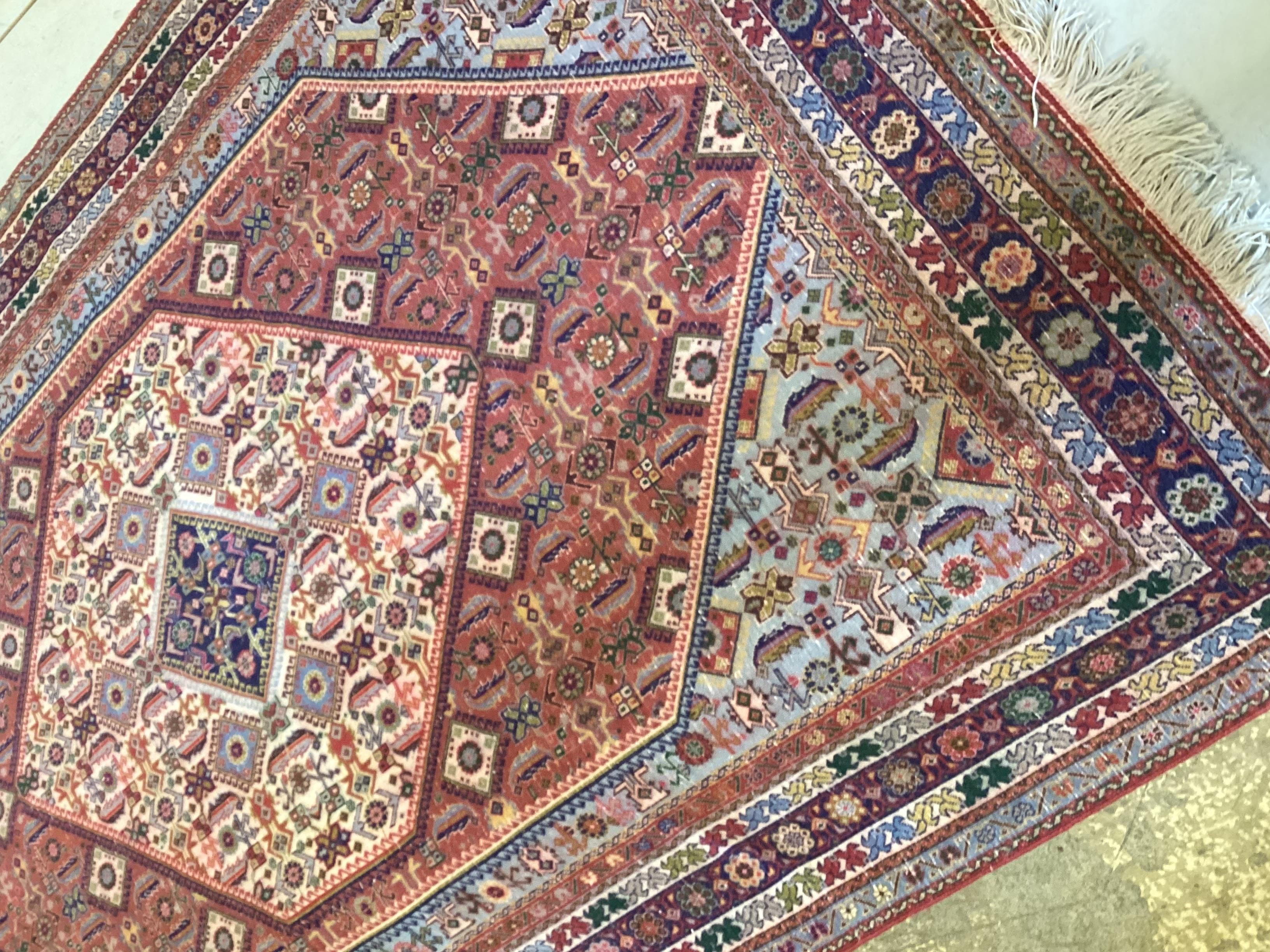 A North West Persian red ground rug, 188 x 127cm